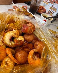 Signature Kimkey boil bag with shrimp and hush puppies