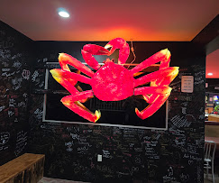The giant Kimkey crab mounted on a chalk-covered wall inside the restaurant, signed by customers