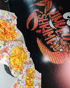 Kimkey seafood boil served on the wax paper with the Kimkey crab mural in the background